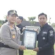 Kapolres Blitar AKBP Arif Fazlurrahman menyerahkan piagam penghargaan kepada anggota berprestasi saat Apel Jam Pimpinan di halaman Mapolres Blitar, Selasa (16/12/2025).